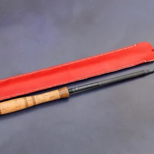 Close up of Mario Diaz signature on a Tenkara Graphite 44 fly fishing rod with cork handle and red leather case
