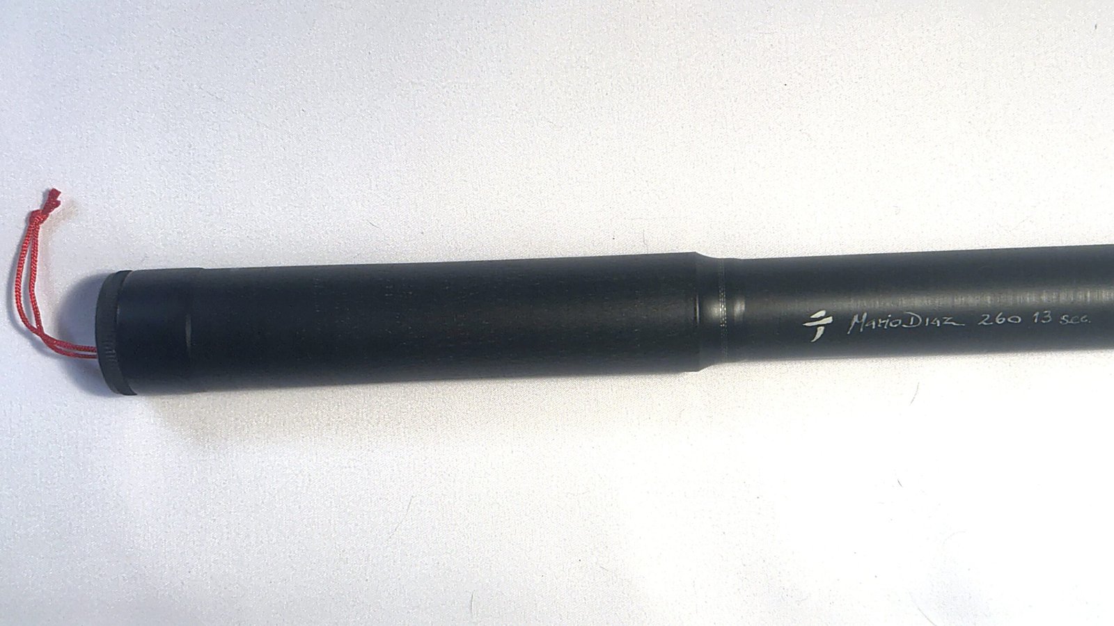 Integrated graphite handle, fully collapsed, with hand-engraved "Mario Diaz · 260 · 13 sec" signature on the Tenkara R7 limited edition rod, numbered 7 of 24
